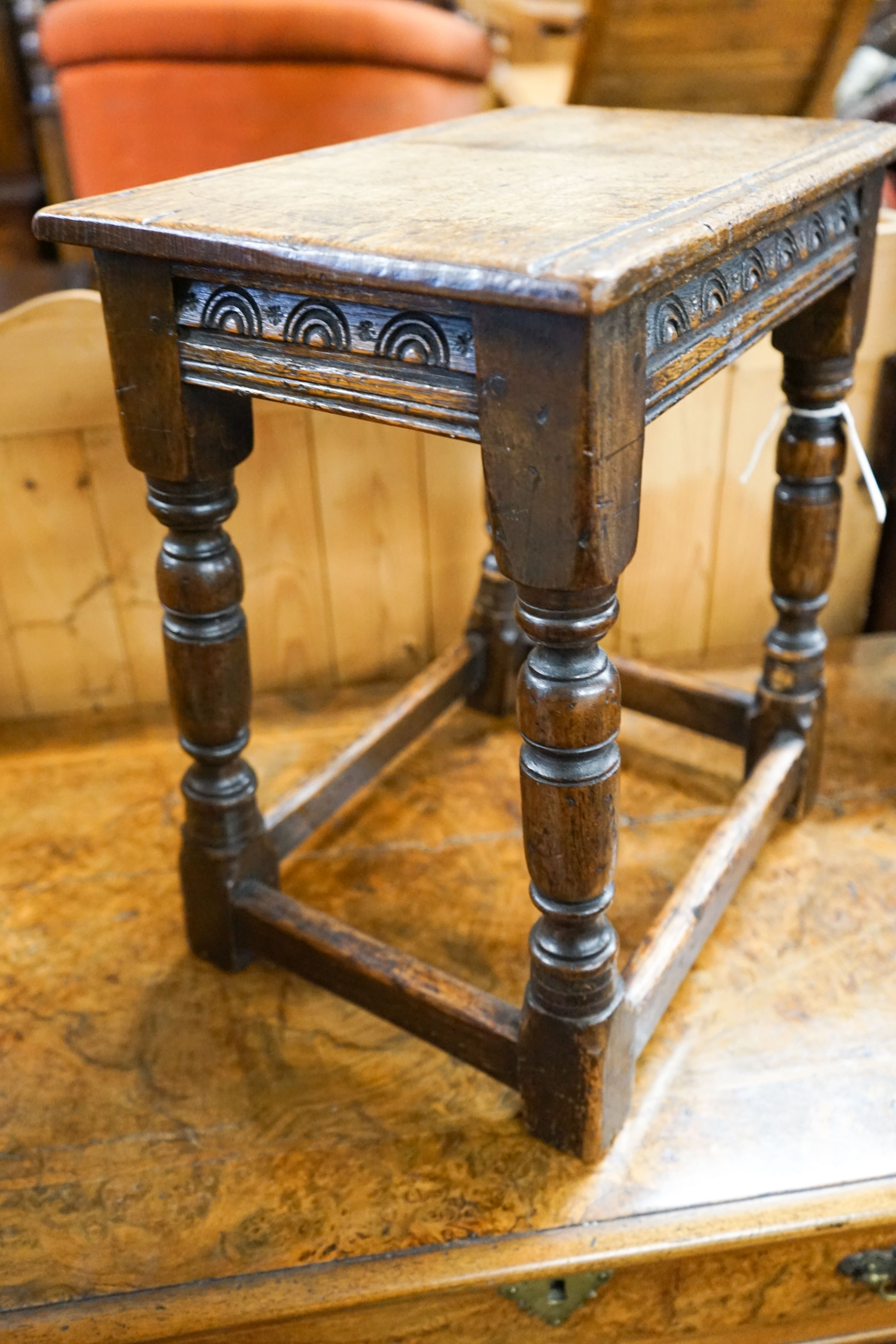 An 17th century style carved oak joint stool on turned supports, length 40cm, depth 25cm, height 45cm